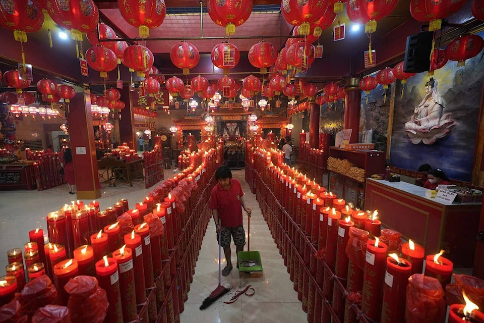 A worker cleans floor at Hok Lay Kiong temple in Bekasi, Indonesia, Sunday, Jan 22, 2023. The Lunar New Year which marks the Year of the Rabbit in the Chinese zodiac. (AP Photo/Achmad Ibrahim)