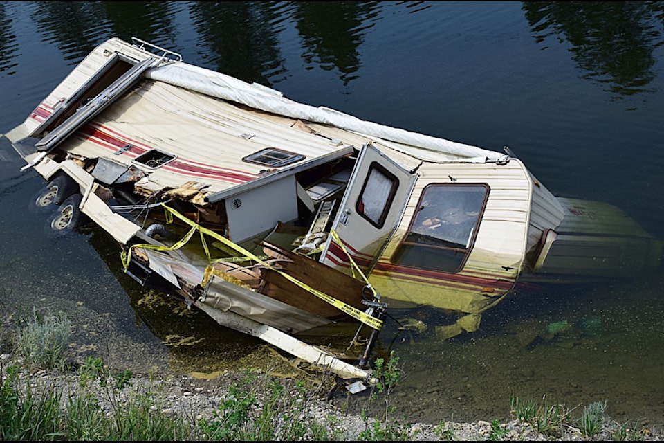 A travel trailer has been sitting in a watery ditch near Wasa for at least four weeks, with residents concerned about water quality and a lack of response to get it removed. Nowell Berg/Submitted.