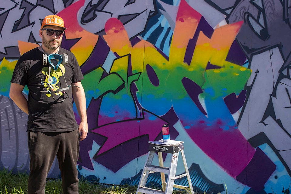Local artist Jamie Cross stands in front of the pride mural he painted to be hung on the wall of Centre64 and utilized as a background for a photo booth for people to snap pictures and celebrate pride. Paul Rodgers photo.