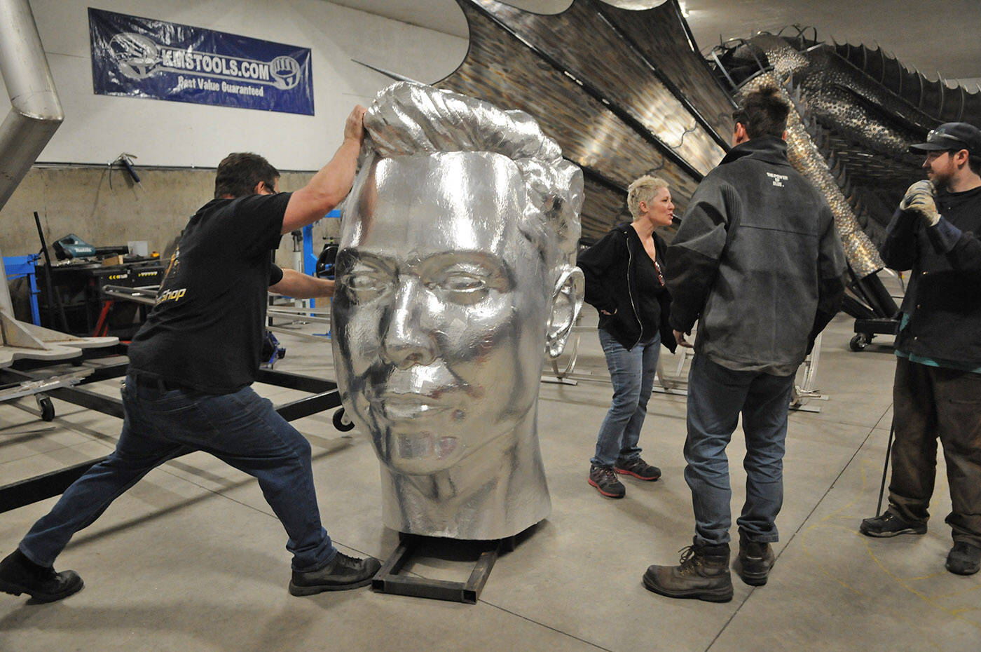 Chilliwack sculptor Kevin Stone (left) moves a gigantic Elon Musk head in his workshop on Tuesday, Jan. 18, 2022. (Jenna Hauck/ Chilliwack Progress)