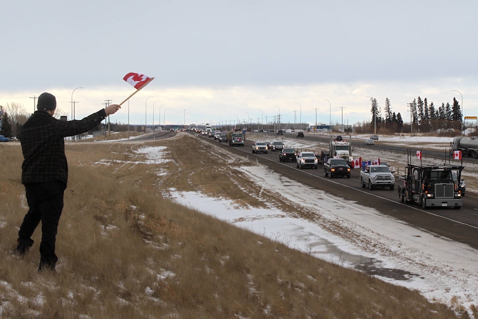 Supporters stopped along Highway 2 on Feb. 5, 2022 as a slow roll convoy made their way from Calgary to Edmonton. The convoy was part of a larger protest against COVID-19 mandates that took place in Calgary, Vancouver, Toronto and Quebec.