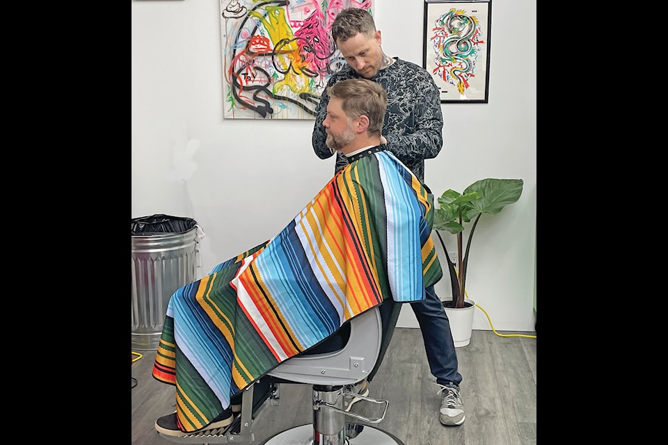 Customer Andrew Mack gets the treatment from barber and stylist, Dustin Esstill at the new Jonny’s Barbershop in downtown Ladysmith. (Duck Paterson photo)