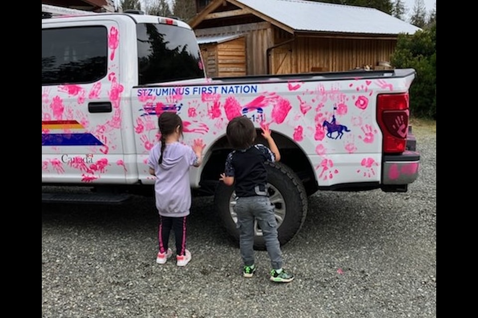 Preschool students decorated the RCMP pickup truck with pink handprints during a visit with Constable Glen Martin and victim services workers on Pink Shirt Day.