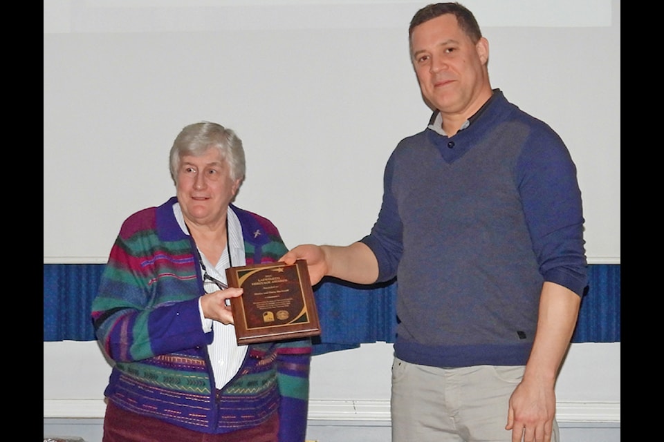 Longtime historian, along with her husband Harry, Shirley Blackstaff receives a 2025 Heritage Award from CVRD Adrea G director Jessie McClinton. Along with a group of dedicated volunteers, the Blackstaffs reconstructed a replica of the Koksilah one room school house on their property in south Ladysmith. (Duck Paterson photo)