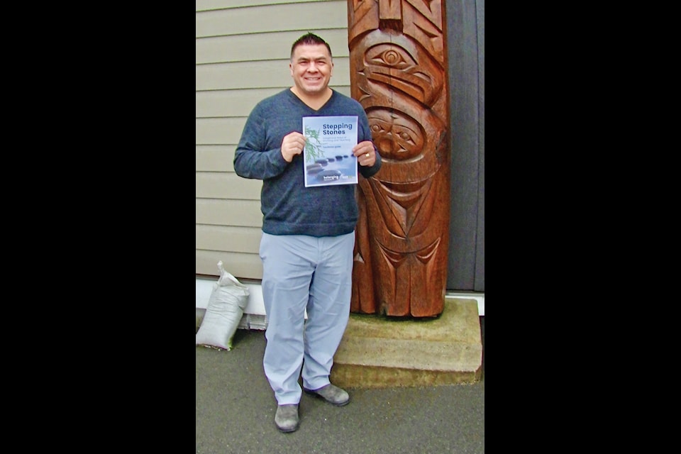 Local Stz’uminus educator and School District 68 Trustee Tim Harris proudly displays a first edition of the new Stepping Stones guide. The program is aimed at Indigenous youth leaving home care and transitioning into the mainstream. The Indigenous Ways of Knowing and Teaching was put together by Harris and a group of local educators and youth workers. (Duck Paterson photo)
