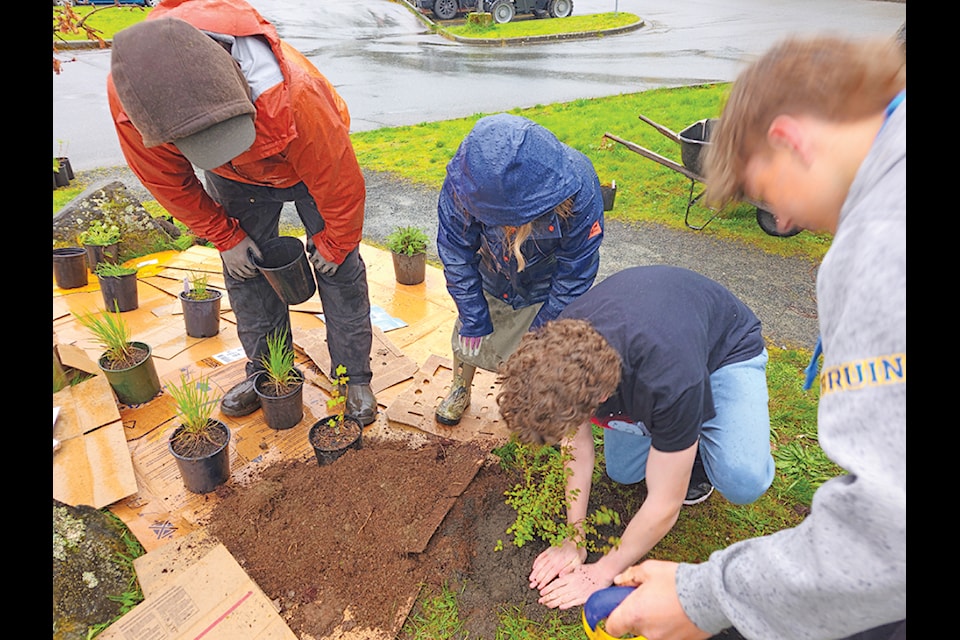 In spite of the rainy weather the students and teachers, from the school, were successful planting a varied selection of indigenous plants both inside the school as well as outside. (Submitted photo)