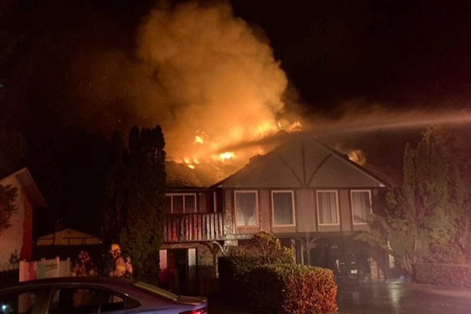 This photo shows crews battling the fire at 7987 Galbraith Cres. that caused extensive damage and displaced six residents early Sunday morning. (Central Saanich Fire/Department Twitter)