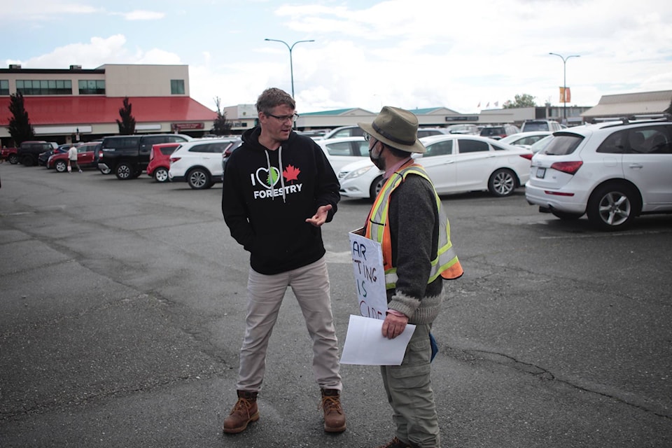Carl Sweet (left) speaks with Rod Burns before the march from Logger Mike to MLA Michele Babchuk’s office in Campbell River. The men were from two different sides of the issue of old growth logging in B.C. Photo by Marc Kitteringham / Campbell River Mirror