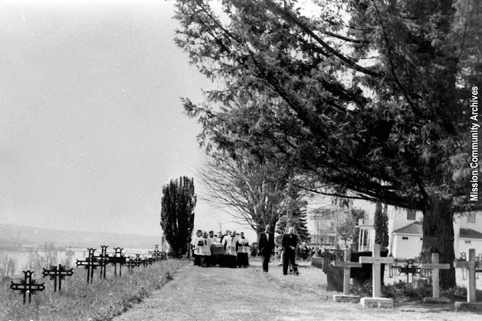 A 1958 photo of Father Falhman’s funeral procession at the Oblates of Mary Immaculate Cemetery at St. Mary’s Residential School. The graves on the hill left-hand side of the photo are now covered by row of blackberry bushes. Mission Community Archives photo.