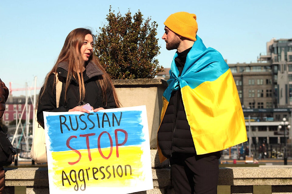 Nataliia Kuksa, left, was born in Kyiv and was up through the night contacting everybody she knows back home. Members of Greater Victoria’s Ukrainian community at a solidarity gathering outside the B.C. legislature on Feb. 24, less than a day after Russia’s military attacked Ukraine on multiple fronts. (Jake Romphf/News Staff)