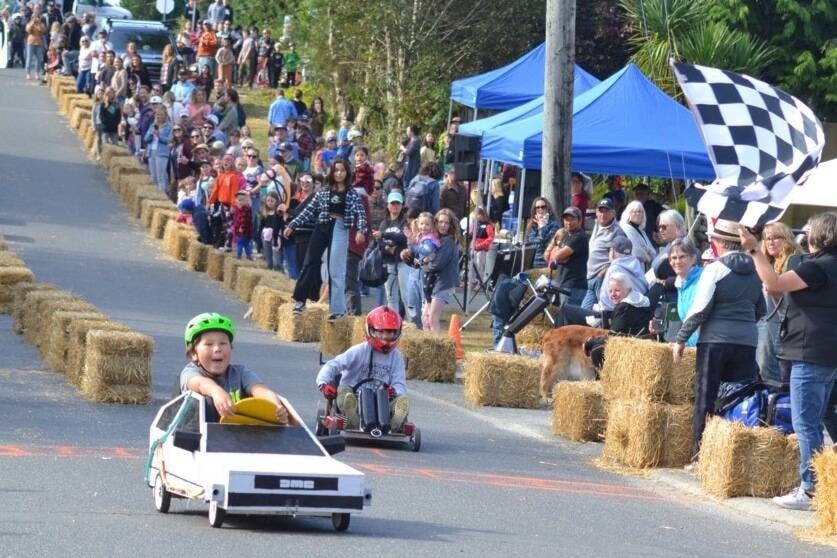 PHOTO FINISH: Dorian Baird, 11, zips over the finish line in his Delorean time machine soap box race car during the Sept. 17 Dustin Riley Soap Box Derby at Ucluelet’s Bay Street. Dorian went on to win top spot of the Tier B group. (Nora O’Malley photos)