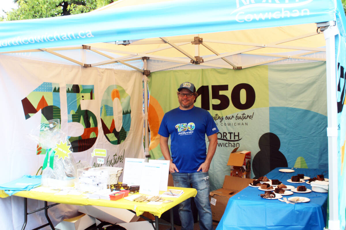 North Cowichan recreation programmer Trenton McLaren mans the North Cowichan 150 tent. (Photo by Don Bodger)