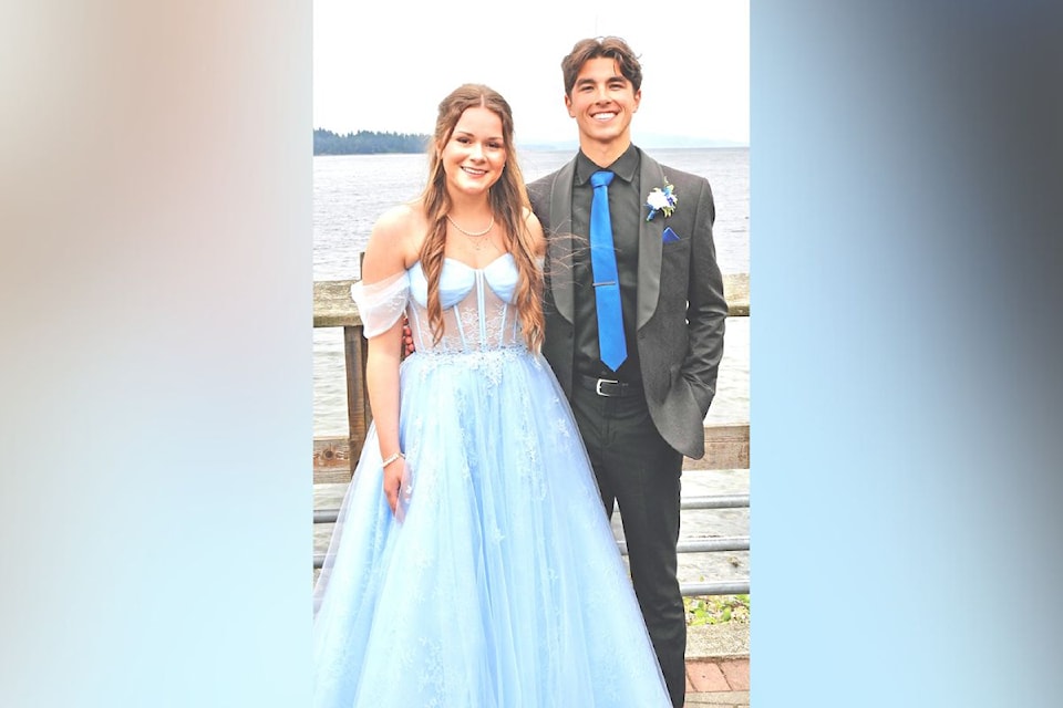 Valedictorians Jorie Benjamin (left) and Zack Silvey at the prom parade held at Transfer Beach.     