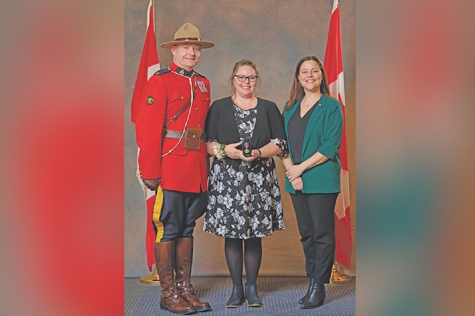 Kerrie Vockeroth receives the King Charles III Coronation medal on Saturday Jan. 25. Pictured with Vockeroth is RCMP constable Josh Waltman and Nanaimo---Ladysmith MP Lisa-Marie Barron. Cst. Waltman was also a King Charles medal recipient, last summer.