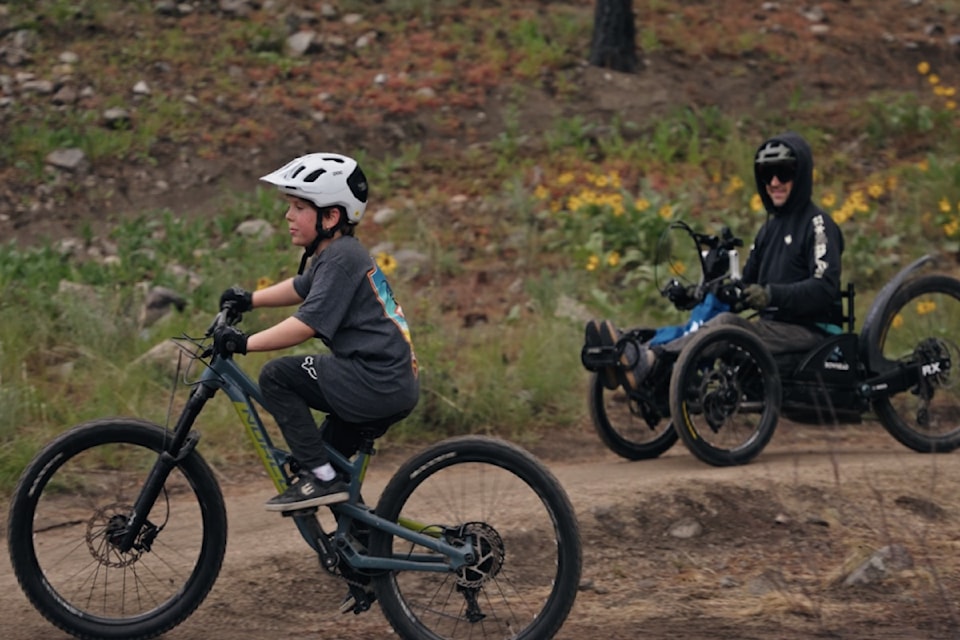 Josh Dueck and son ride the adaptive trail at Lake Country's bike park on May 3, 2025. 
