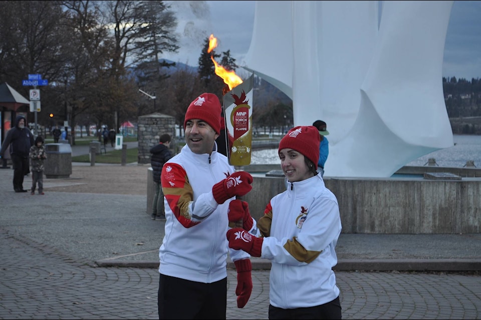 Mayor Basran switches with torch bearer Christina Acton at the beginning of the relay. Photo: Mackenzie Britton/Capital News