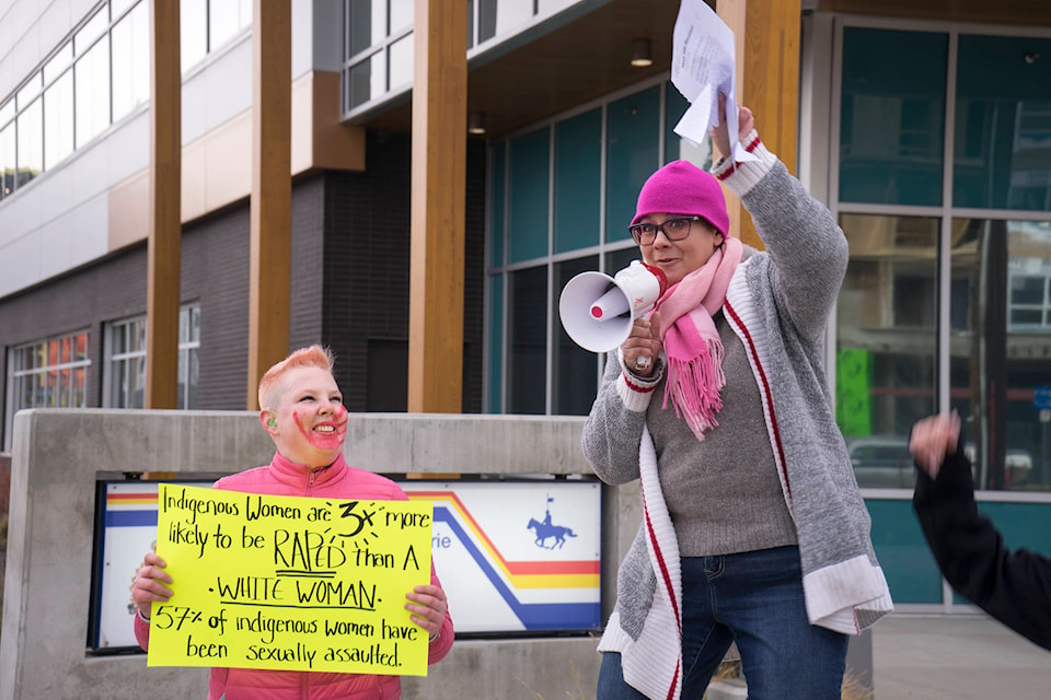Aden Withers (left) and Heather Friesen (right) during the protest of the Kelowna RCMP on Nov. 23. (Michael Rodriguez - Kelowna Capital News)