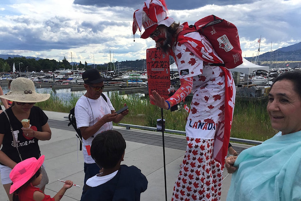 Locals snap pictures with Canada Day enthusiast during celebrations in downtown Kelowna. (File)