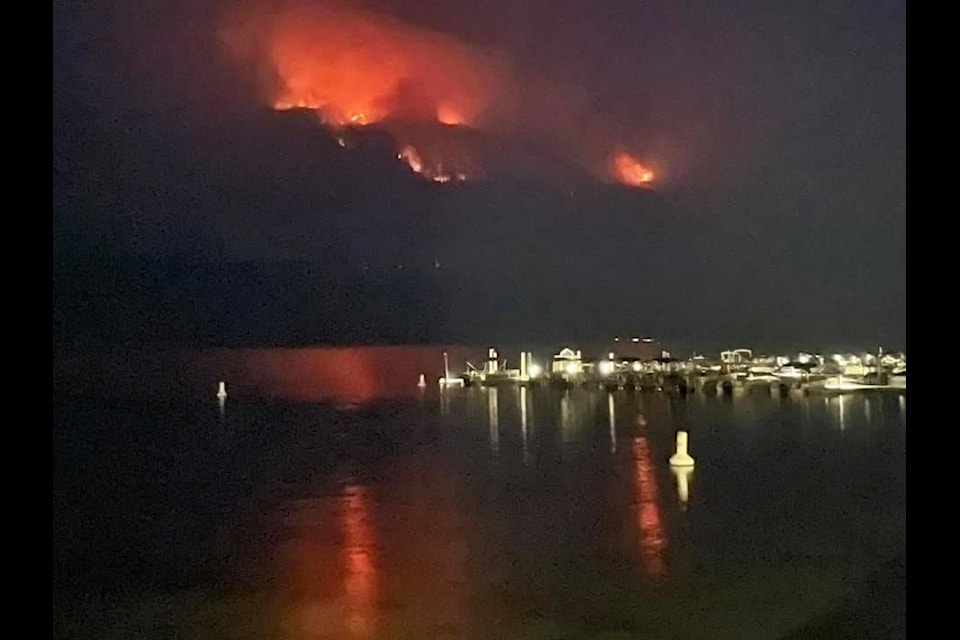 Fires glow on the hills above Mabel Lake July 14, as seen from the Enderby side from the marina. (Bruce Ingleson photo)