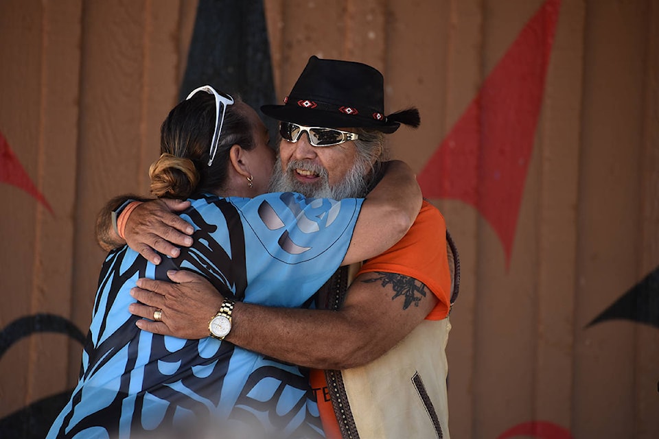Semiahmoo First Nation Councillor Joanne Charles and former Chief Willard Cook share a celebratory hug at a July 28 event marking the lifting of the boil water advisory on Semiahmoo lands. (Alex Browne photo)