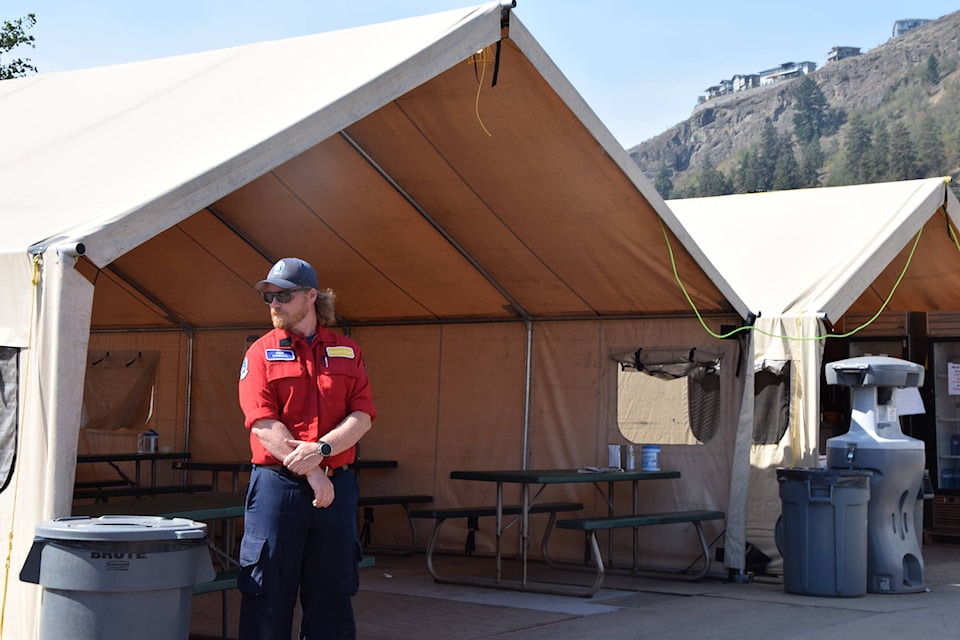 BC Wildfire Services logistics section chief Cian Carroll shows media the dining area at the Vernon fire camp on the Kin Race Track grounds Aug. 12, 2021. (Caitlin Clow - Vernon Morning Star)