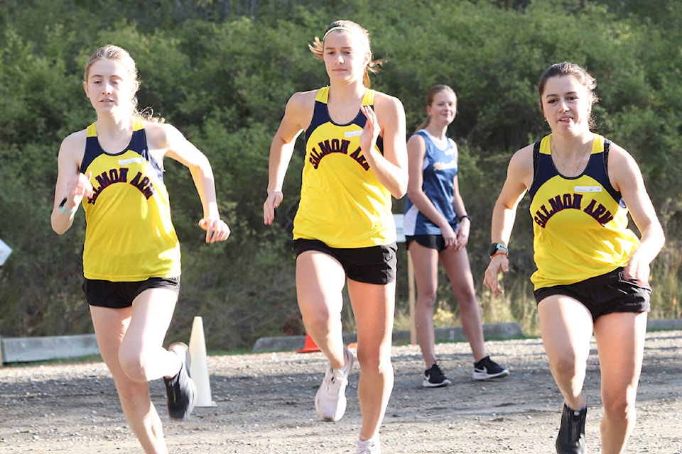 Salmon Arm Secondary runners Sophie Hamilton (from left), Taylor Menzies and Sama Vukadinovic warm up before the start of the North Zone five-kilometre event Wednesday, Oct. 13, at Coldstream’s Kalamalka Lake Provincial Park. (Roger Knox - Black Press)