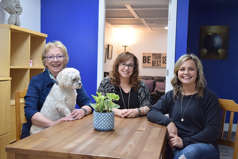 Carole Fawcett, from left, Jeunesse Pearson and Jessa Joles, along with Chloe the therapy dog, are part of the OK Valley Counselling team in Vernon. (Caitlin Clow - Vernon Morning Star)