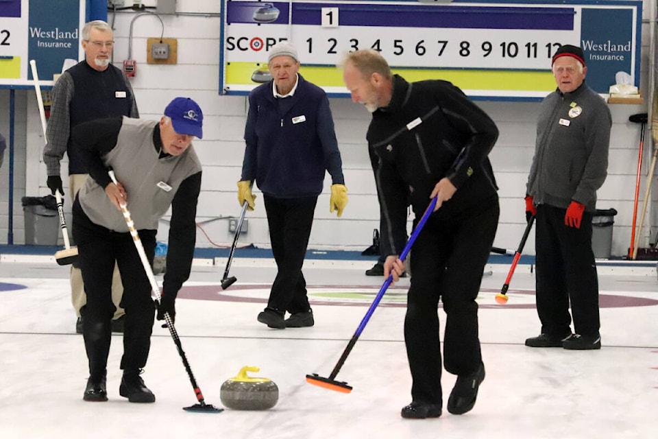 John Baia, 93, (centre) watches his stone during action at the Senior Men’s Drop-In Curling League at the Vernon Curling Club. Baia, from Lake Country, has been playing in the league for 18 years. (Roger Knox - Morning Star)