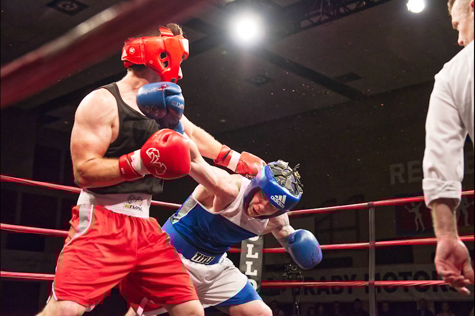 Jordan Barin of Salmon Arm’s Bulldog’s Boxing dodges a blow while connecting with the chin of opponent Tyson Chamberlain, of the Kamloops Boxing Academy, in a novice elite bout. Barin dominated the fight and was declared the winner during the Hit2Fit fundraising event at the SASCU Recreation Centre on Saturday, May 7, 2022. (Lachlan Labere-Salmon Arm Observer)