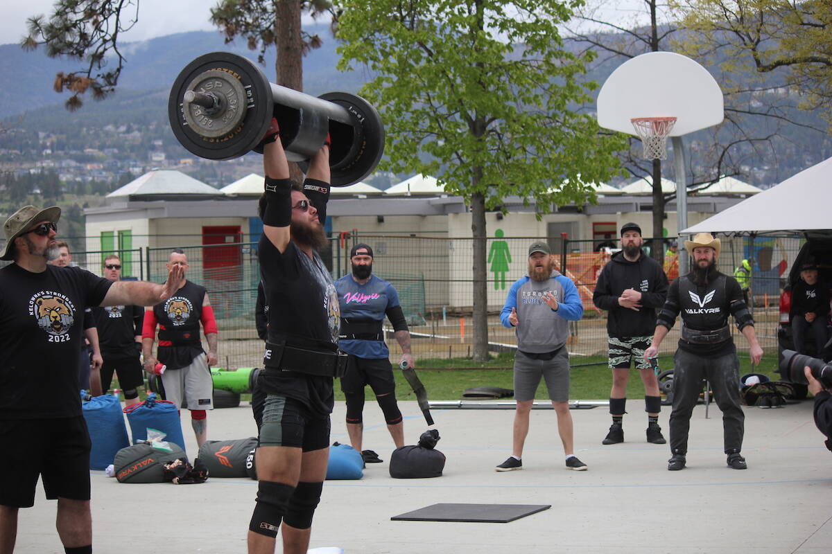 Kelowna's Strongest spokesperson Hans Fuhrmann takes part in the log lift competition (Photo - Jordy Cunningham/Capital News)