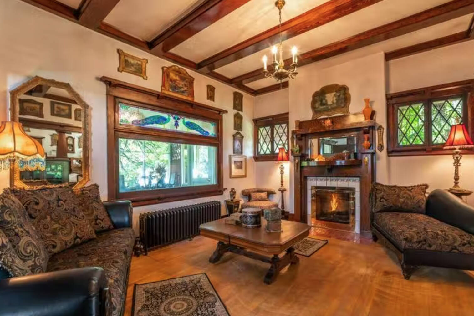 This is one of the sitting room areas of the Riordan House up for sale. Notice the peacocks in the stained glass windows. (Remax photo)