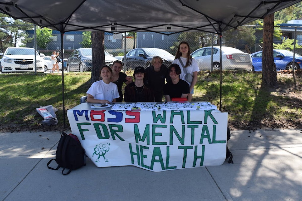 Grade 10 student Delaney Neukomm (far right) with fellow classmates selling t-shirts at the first MBSS Walk for Mental Health. (Brittany Webster/West K News)