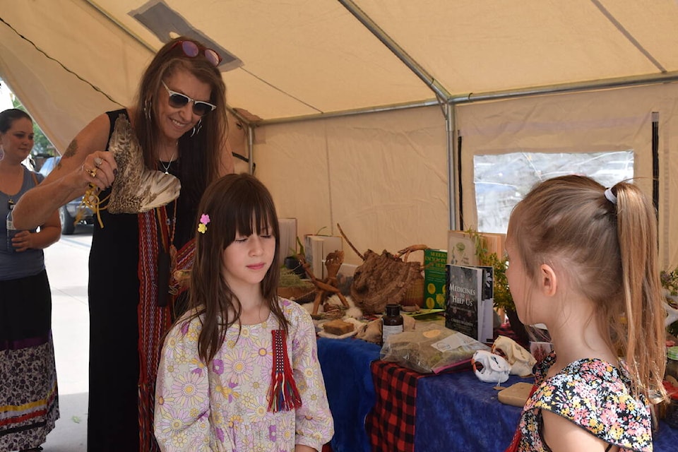 Girls in the smudging tent at the Kelowna Metis Rendezvous on June 21, 2023. (Brittany Webster/Capital News)