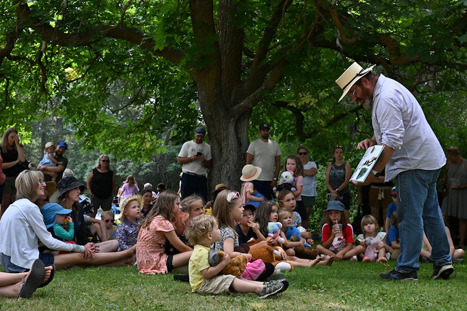 Chris Mathieson reads a story to the kids during the Teddy Bears’ Picnic at the Keremeos Grist Mill and Gardens on Saturday, July 8. (Brennan Phillips/Review)