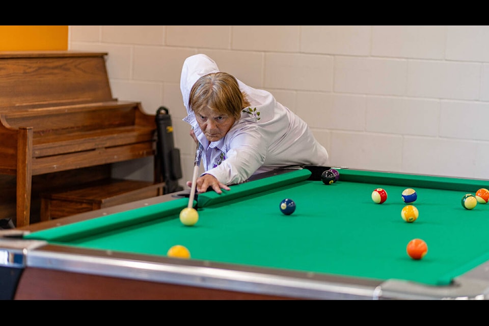 An 8-Ball player lines up his shot. (BC 55-Plus Games photo team)