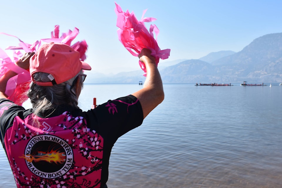 Fellow racers cheer on the breast cancer survivor boats nearing the finish line in the finals on Sunday. (Monique Tamminga Western News)