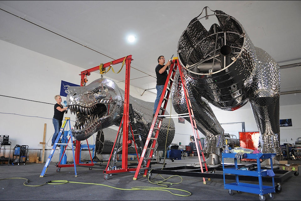 Kevin Stone and wife Michelle were putting the finishing touches on a 17,000-pound, stainless-steel T. rex on Thursday, Sept. 14, 2023, just days before it was to be shipped from Chilliwack to Penticton. (Jenna Hauck/ Chilliwack Progress)