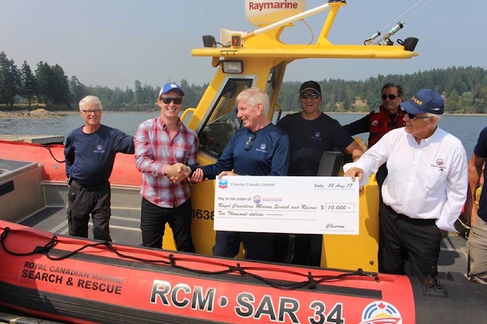 It’s a happy day for Mill Bay’s marine search and rescue team when Chevron steps up with a big cheque. (Submitted)