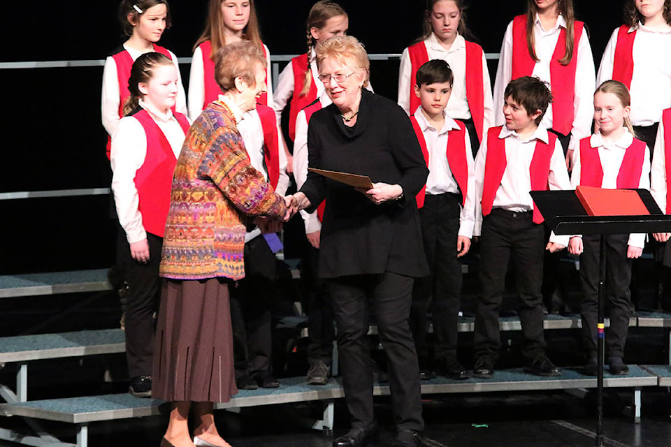 Sheila Hilton-Johnson of the Cowichan Valley Youth Junior Choir receives her group’s award from Cowichan Music Festival vocal chair, Jean Davis, left. (Lexi Bainas/Citizen)