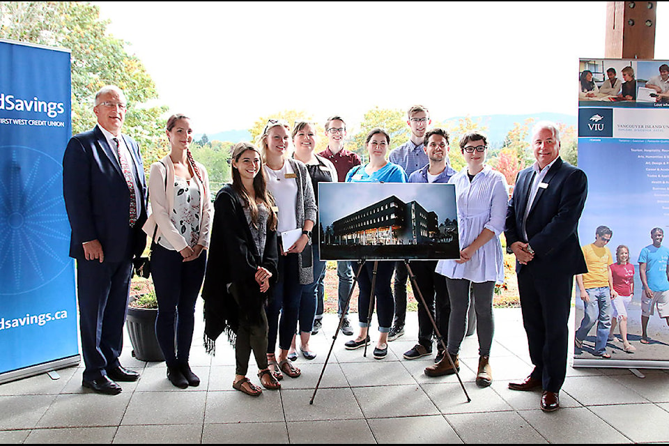 VIU’s Ralph Nilsen, left, and Island Savings’ Randy Bertsch, right, join a group of Cowichan Campus students after the donation announcement. (Lexi Bainas/Citizen)