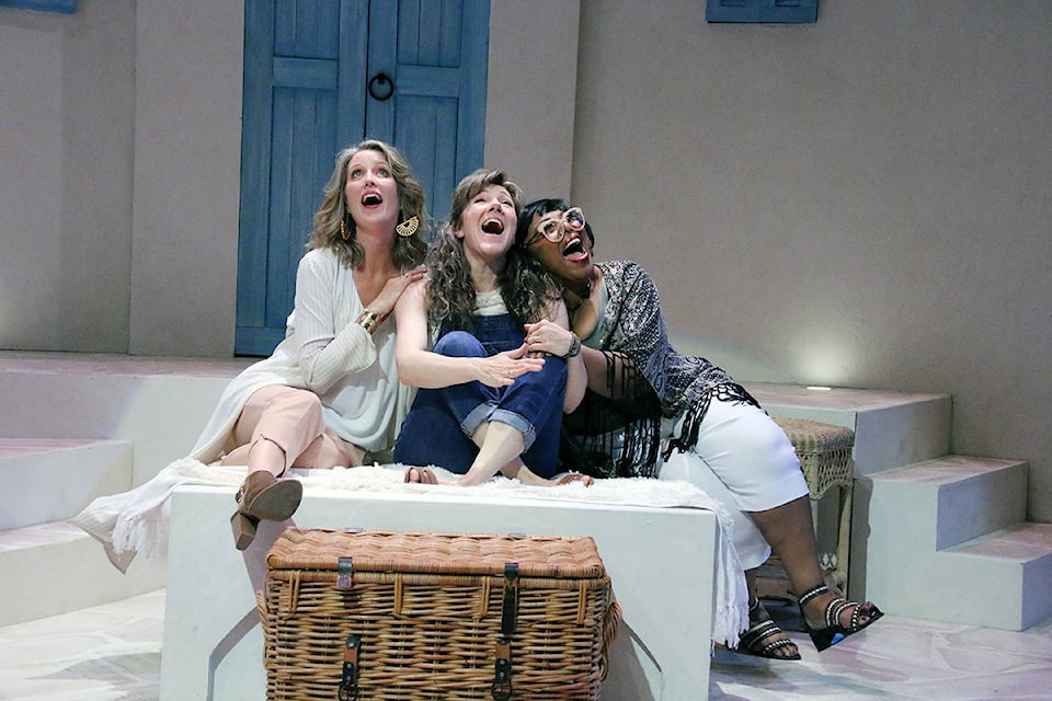 Tanya (Erin Ormond), Donna (Stephanie Roth, and Rosie (Jenni Burke), laugh together in this scene from a rehearsal of ‘Mamma Mia!’ at the Chemainus Theatre. (Lexi Bainas/Citizen)