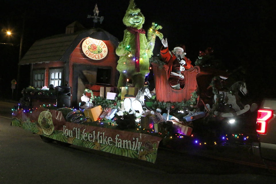 The Grinch joins Santa on the Country Grocer float in the Lake Cowichan Xmas parade. (Lexi Bainas/Gazette)