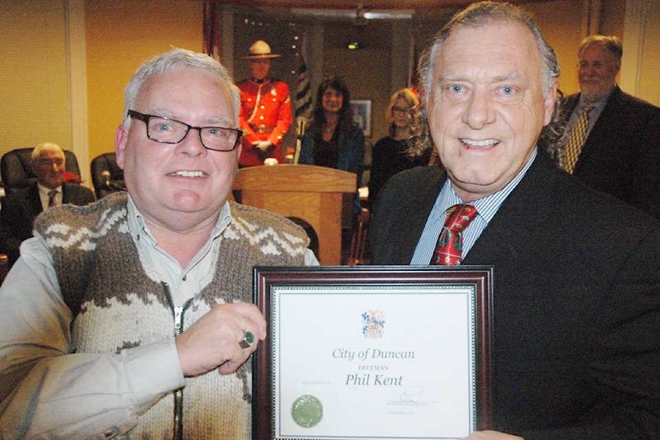 Former Duncan Mayor Phil Kent, left, is presented with the rare Freeman of the City Award by Duncan councillor Tom Duncan at a ceremony at City Hall on Dec. 2. (Robert Barron /Citizen)