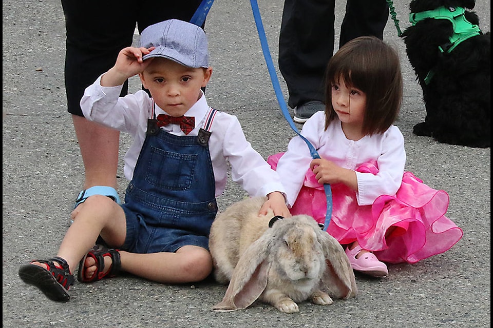 Hayden and Harlow Turner sit with Kirby, the lop-eared rabbit, an unusual pet that attracted a lot of admirers during the annual activities at Saywell Park during Heritage Days. (Lexi Bainas/Gazette)