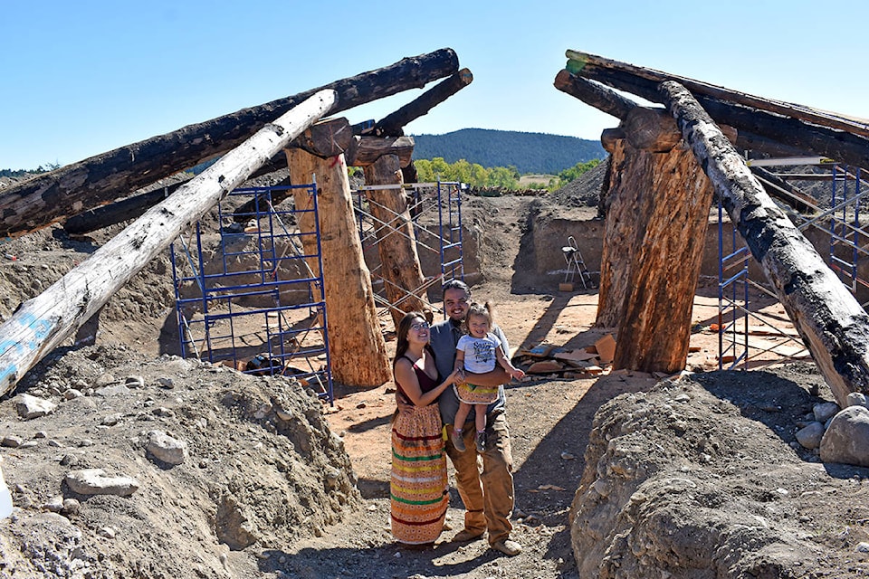 Loretta Jeff Combs and Peyal Laceese with their daughter Nildziyenhiyah stand in front of their pit house which they hope to be able to move into next spring. (Rebecca Dyok photo)