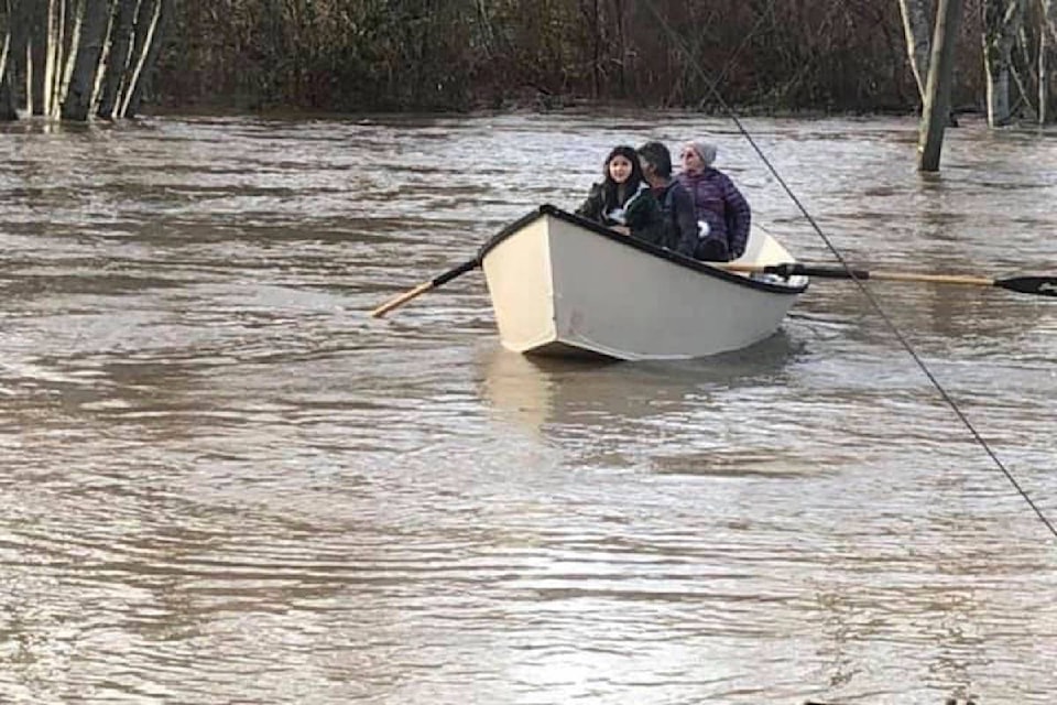 Sahilton Road, behind the Old Farm Market south of Duncan. A crew from Cowichan Tribes rowing residents to safety. (Siona Moon photo)