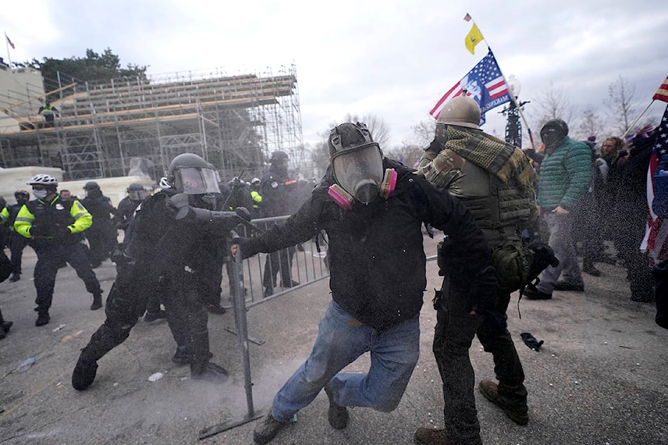 Trump supporters try to break through a police barrier, Wednesday, Jan. 6, 2021, at the Capitol in Washington. As Congress prepares to affirm President-elect Joe Biden’s victory, thousands of people have gathered to show their support for President Donald Trump and his claims of election fraud. (AP Photo/Julio Cortez)