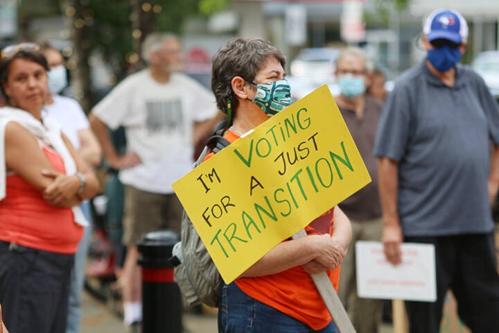 A woman displays a sign advocating for a just transition away from fossil fuels during a climate rally in Duncan on Wednesday, Sept. 8. (Kevin Rothbauer/Citizen)