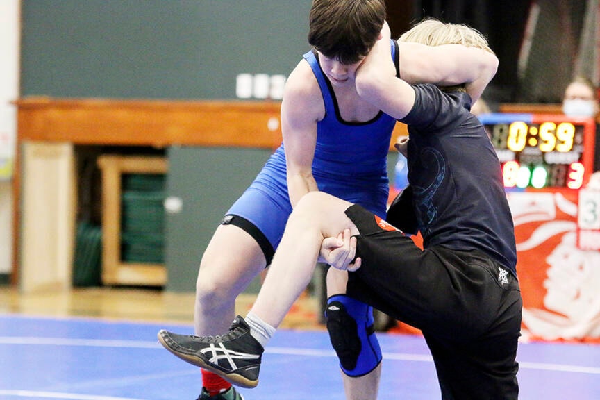 Quinn Bond of Queen Margaret’s School (blue singlet) takes on a wrestler from Spectrum during last Saturday’s dual meet at QMS. (Kevin Rothbauer/Citizen)