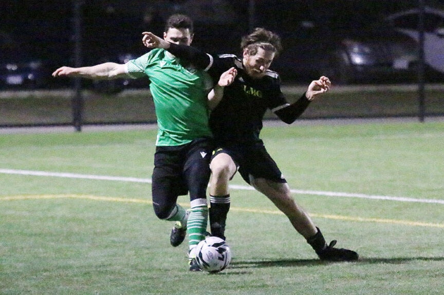 Cowichan LMG’s Connor Crichton battles a Vic West player for the ball during the teams’ game at the Sherman Road turf last Friday. (Kevin Rothbauer/Citizen)